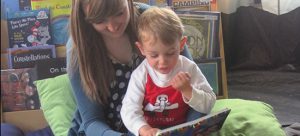 A volunteer for HSDC's Parent-Infant Program reads to a PIP kid.