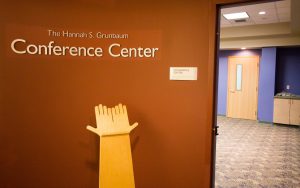 Picture of door to Hannah S. Grunbaum Conference Center, with an ASL hands pedestal.