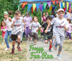 A photo from the 2018 Froggy Fun Run. Kids sprint from the starting line.